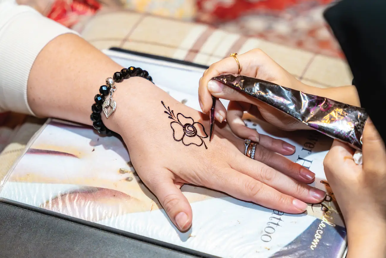 Henna painting at a desert safari camp